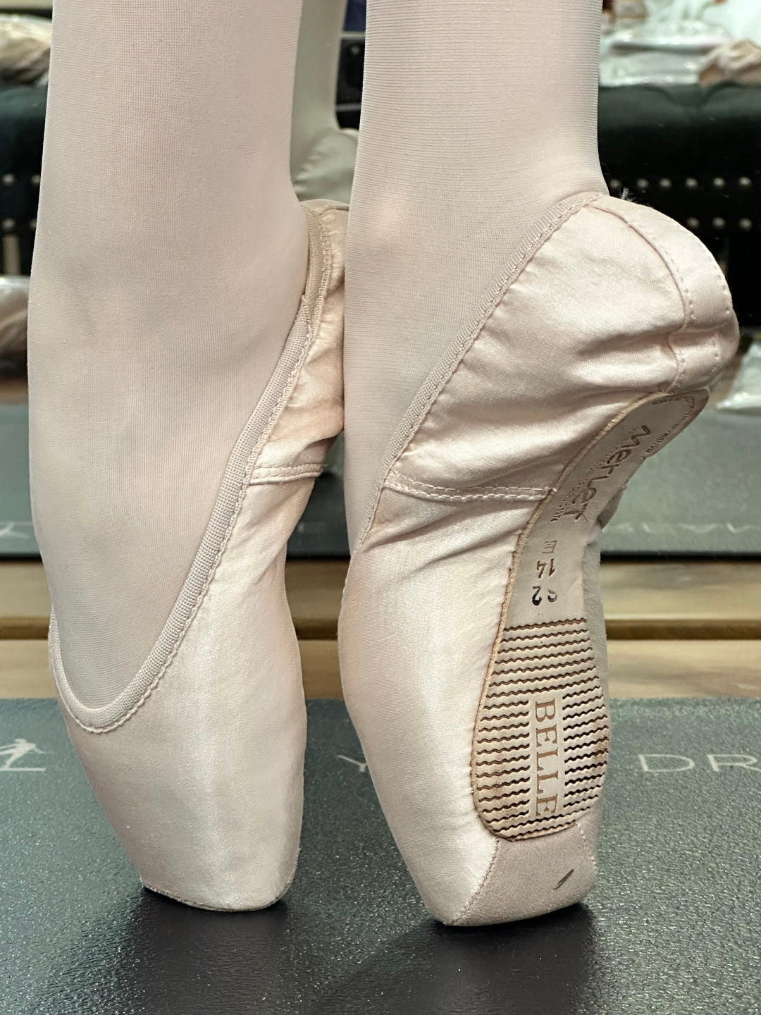 Close-up of beige ballet shoes with &